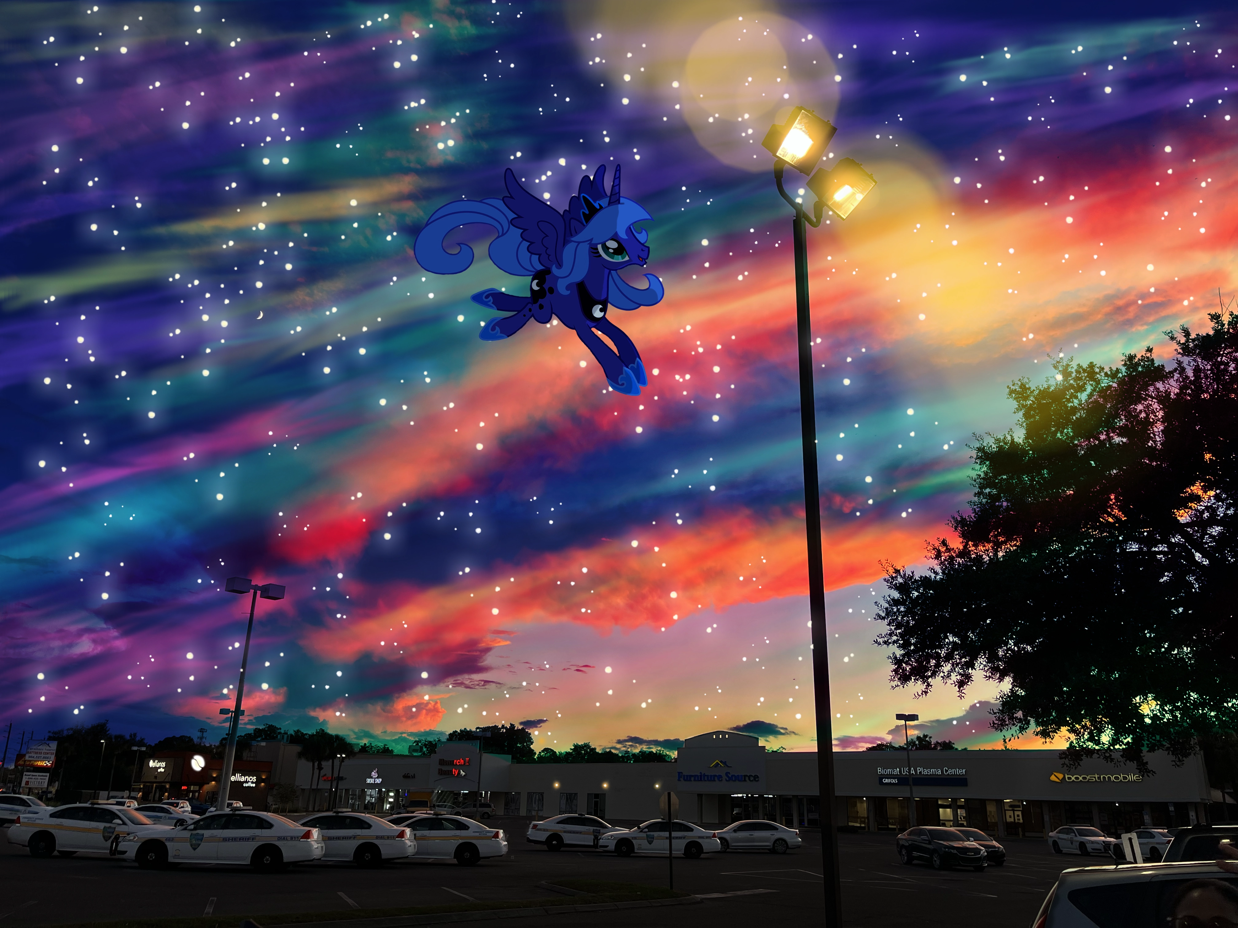 A colorful sky with Princess Luna from My Little Pony next to a light pole.